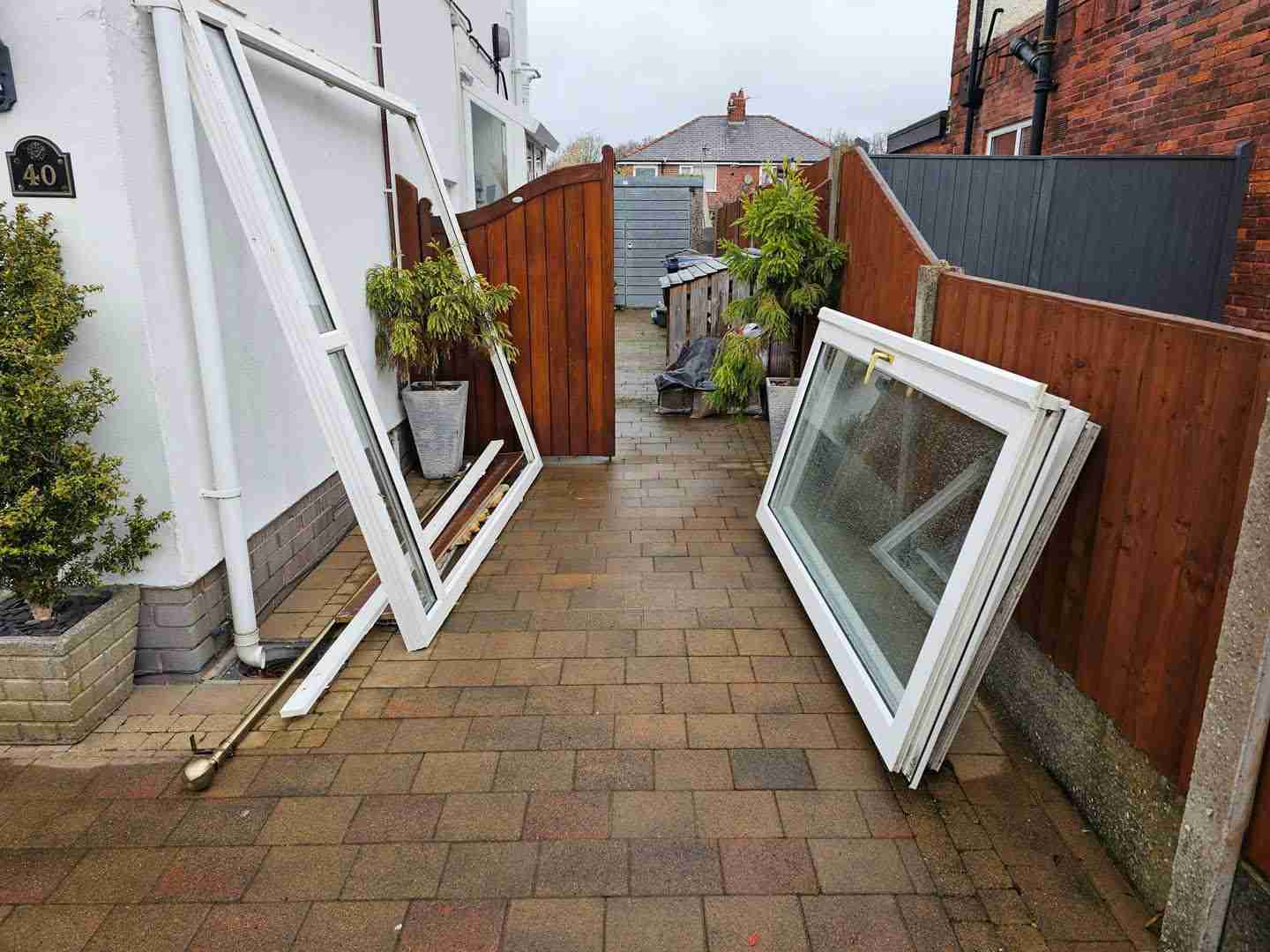 Old UPVC windows and frames cleared from a back yard in Preston by Green Environmental Services